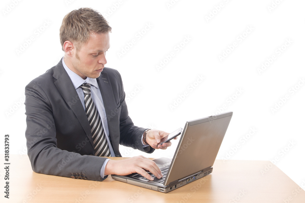 Manager arbeitet am Laptop und telefoniert Manager arbeitet am Laptop und telefoniert