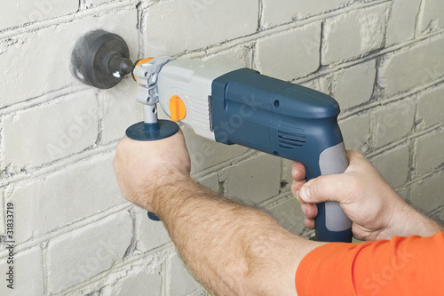 House-builder working with a perforator