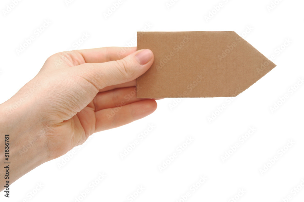 cardboard arrow in a hand isolated on white