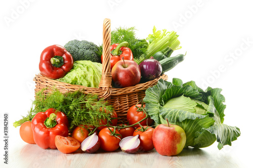 Vegetables in wicker basket  isolated on white
