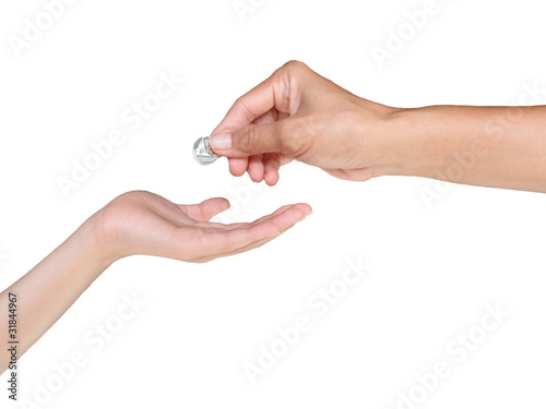 Female hand giving coin for boy hand