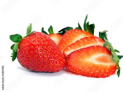 A selection of fresh strawberries sliced and whole