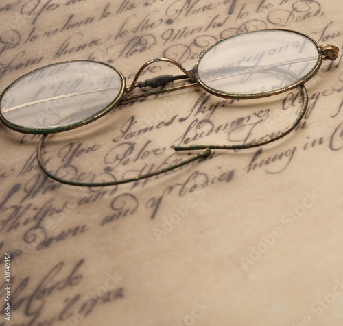 Old glasses on the vintage document