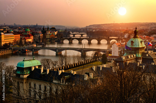 Panoramic view on Charles bridge and sunset Prague lights.
