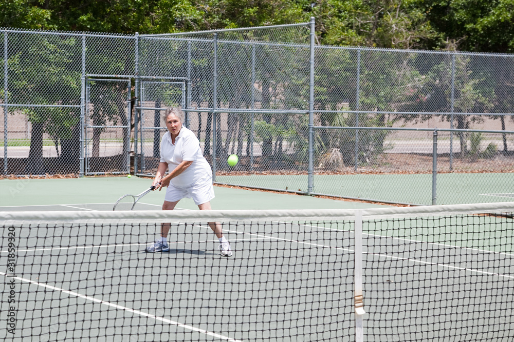 Senior Woman Plays Tennis
