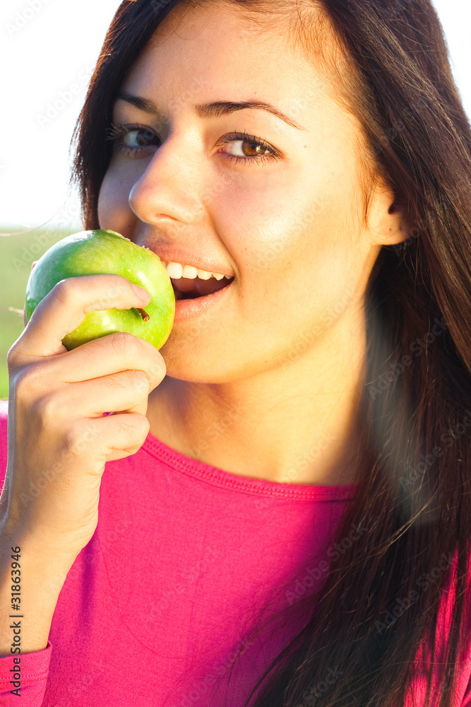 portrait of a beautiful young woman with apple outdoor portrait of a beautiful young woman with apple outdoor