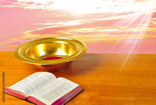 Offering plate on table with bible and bright background