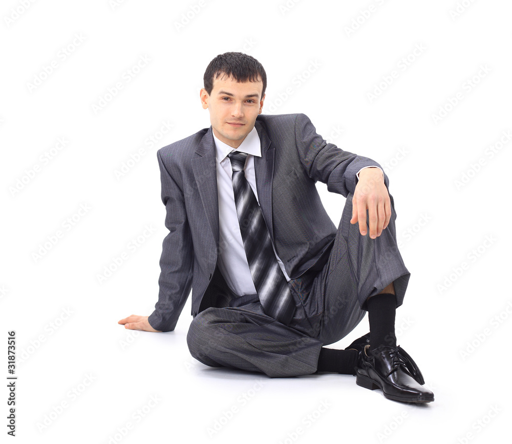 Handsome businessman sitting on the floor . Isolated Handsome businessman sitting on the floor . Isolated