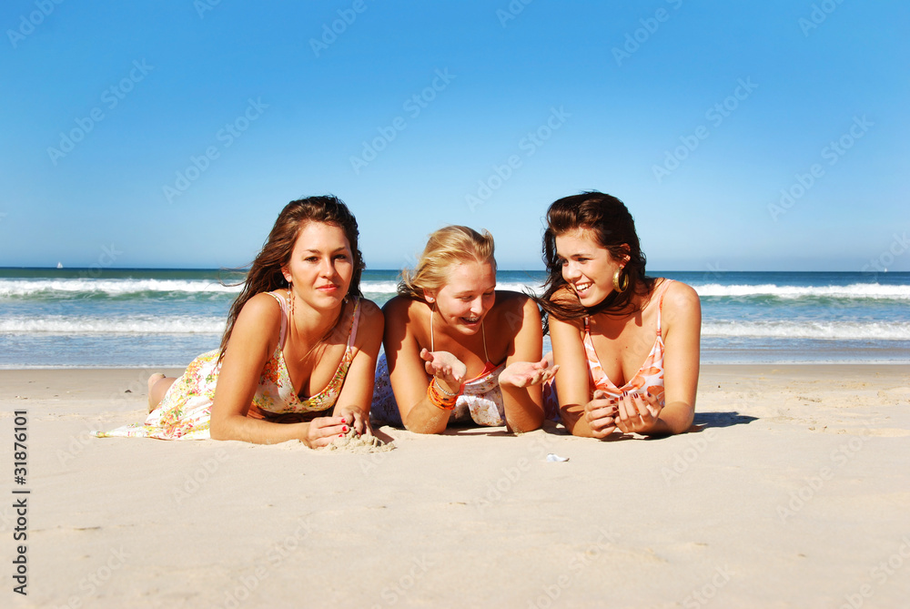 Three young woman having fun on the beach on a summer day Three young woman having fun on the beach on a summer day