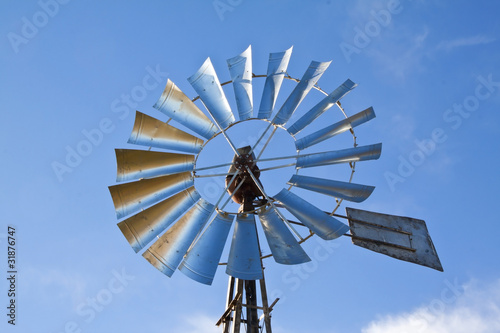 Windmill with sun rising blue sky
