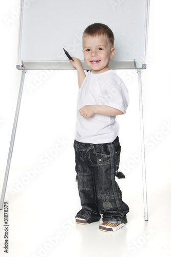 smiling boy next to white board