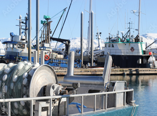 Commercial fishing boat with a net reel in the harbor