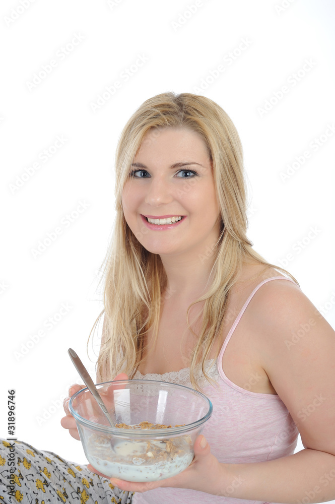 Pretty woman having muesli cereals for breakfast. isolated on wh Pretty woman having muesli cereals for breakfast. isolated on wh