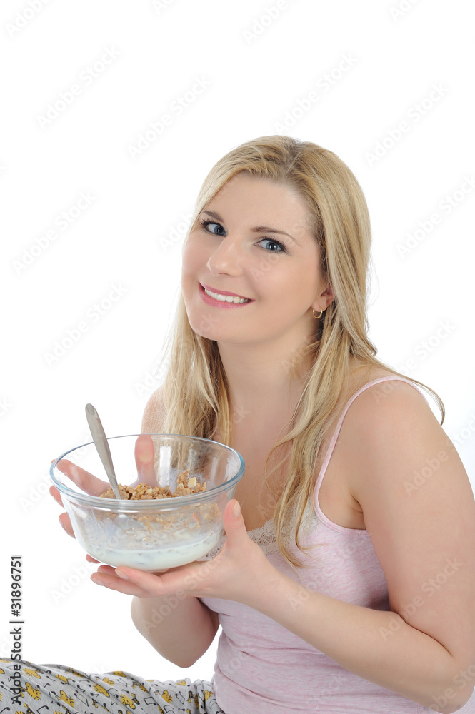 Pretty woman having muesli cereals for breakfast. isolated on wh Pretty woman having muesli cereals for breakfast. isolated on wh