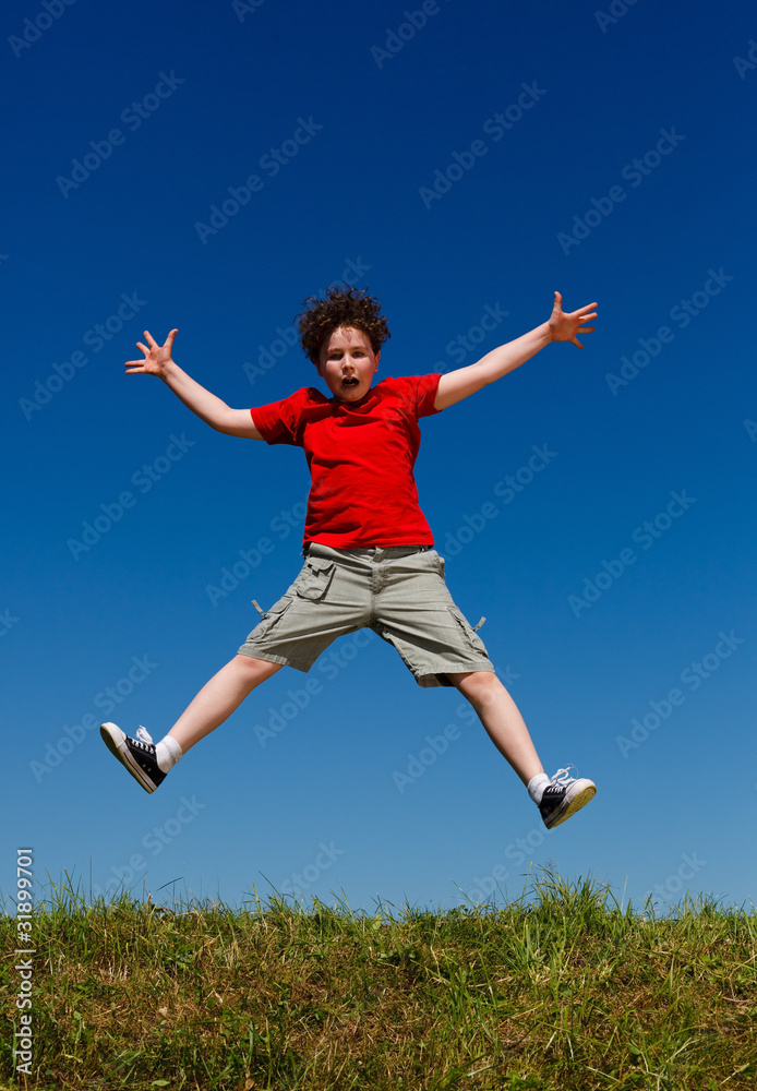 Boy jumping, running against blue sky Boy jumping, running against blue sky