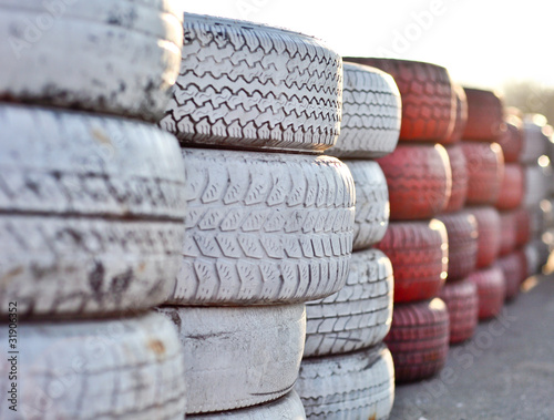 racetrack fence of white and red of old tires