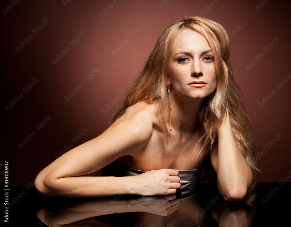 Fashion portrait of sensual young woman on brown background Fashion portrait of sensual young woman on brown background