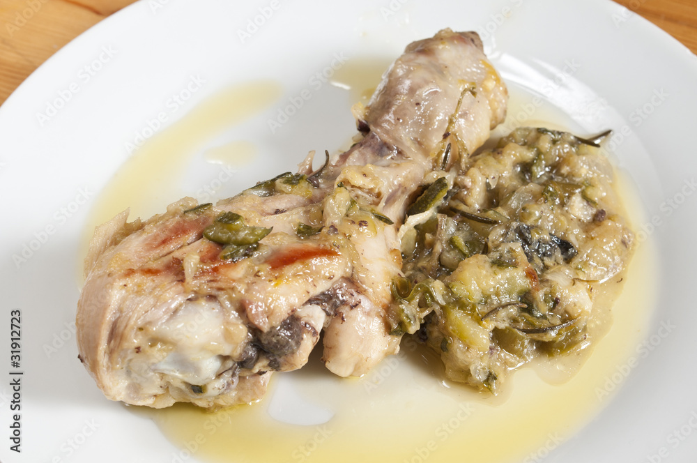 chicken in a pan with onions and zucchini
