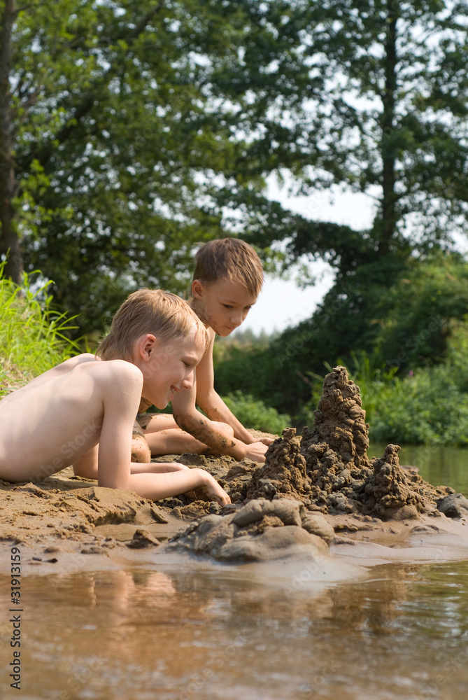 children build a sand castle children build a sand castle