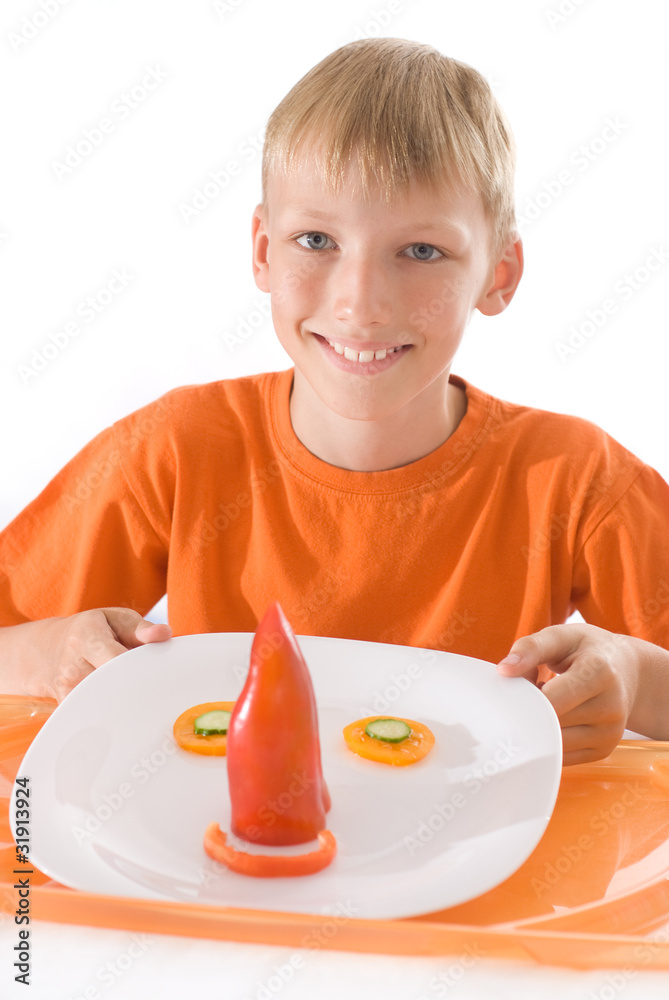 boy holding a plate with vegetables boy holding a plate with vegetables
