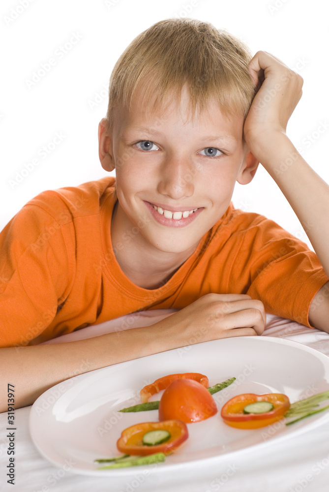 beautiful boy holding a plate with vegetables beautiful boy holding a plate with vegetables