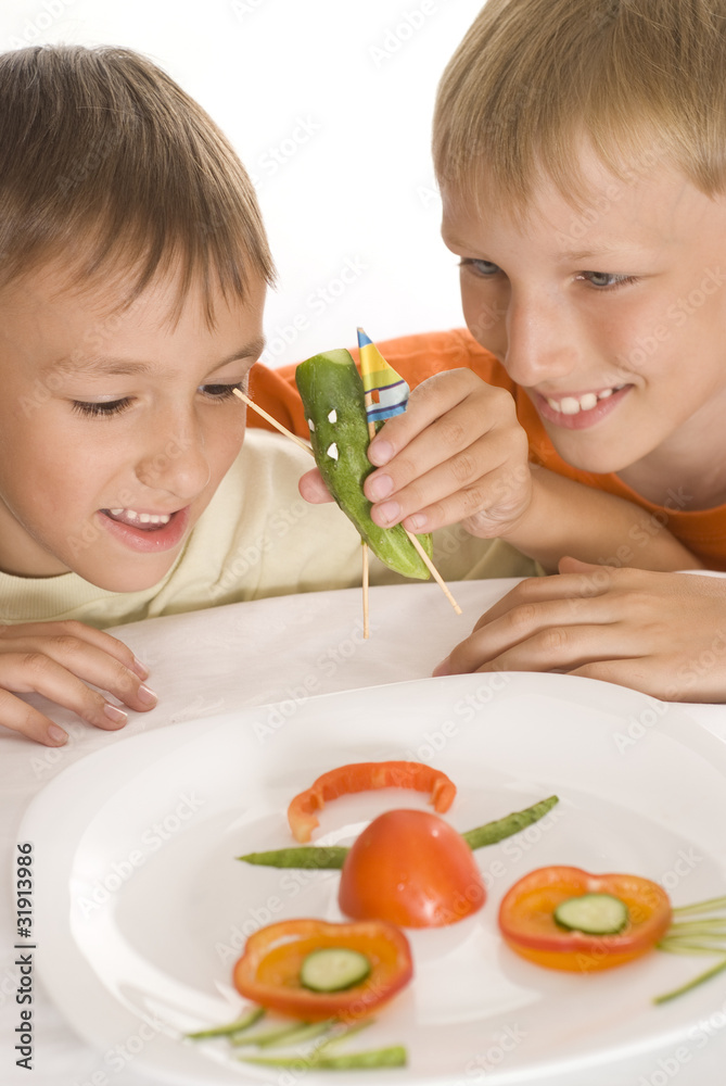 beautiful boys holding a plate with vegetables beautiful boys holding a plate with vegetables