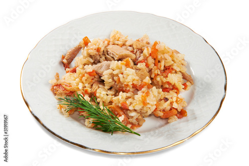Pilaf of rice and chicken on plate isolated