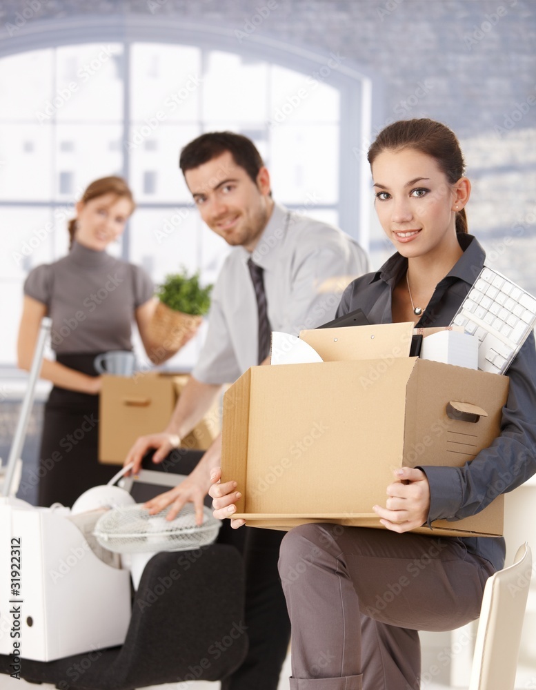 Happy businesspeople moving to new office