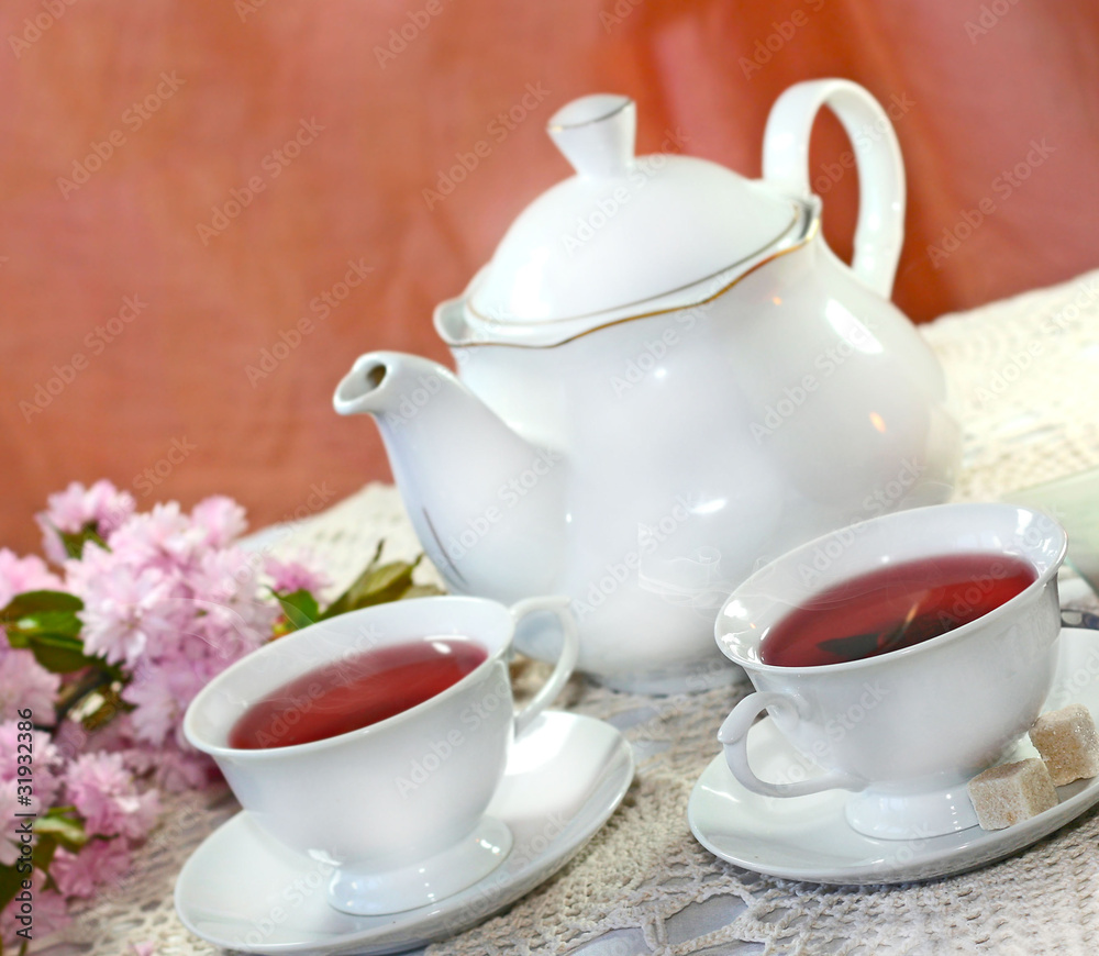 Healthy fruit Tea in a cup and teapot Healthy fruit Tea in a cup and teapot