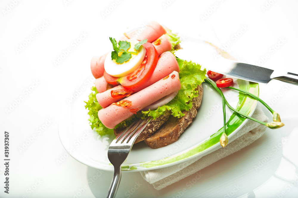 Brown bread with chili sausage slices green salad tomato and egg Brown bread with chili sausage slices green salad tomato and egg