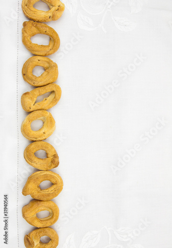 Kitchen Tablecloth Background with a row of Taralli, Copy Space