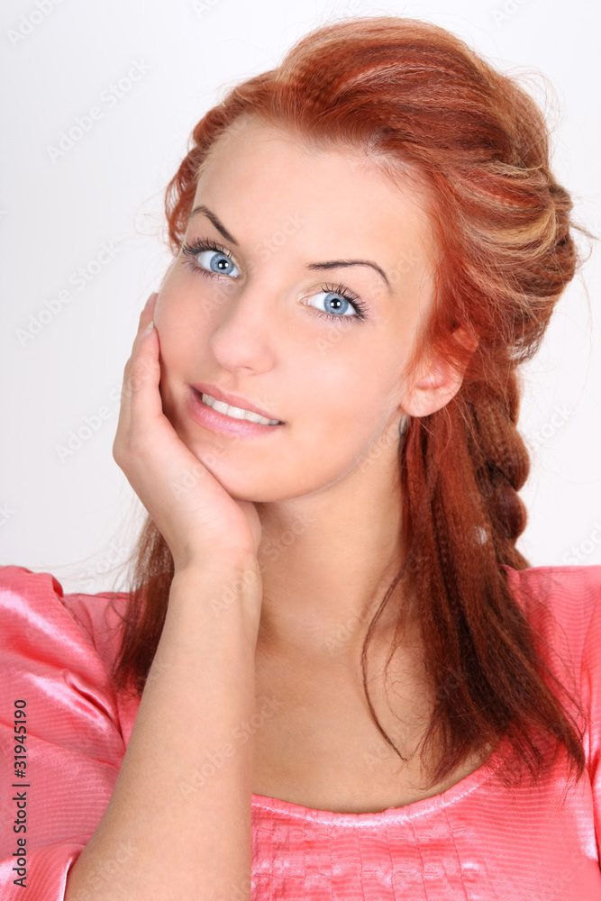 Beautiful red-haired woman in pink smiling Beautiful red-haired woman in pink smiling