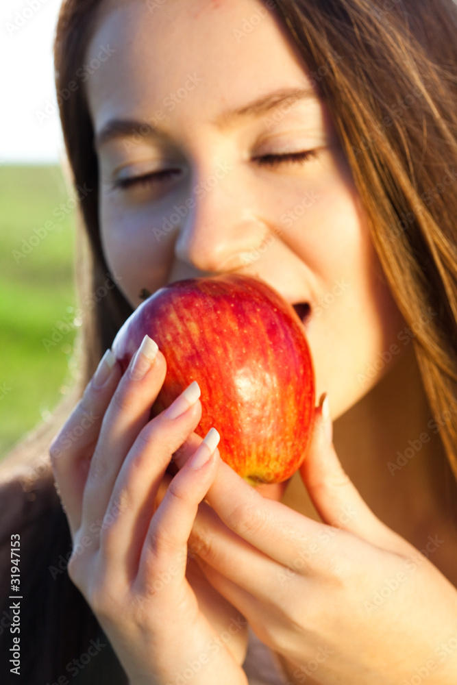 portrait of a beautiful young woman with apple outdoor portrait of a beautiful young woman with apple outdoor