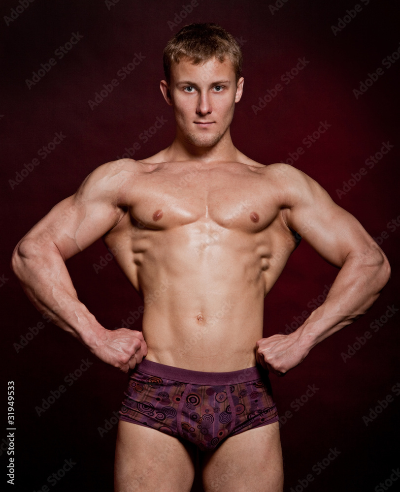 Strong wet sexy nude young bodybuilder posing Strong wet sexy nude young bodybuilder posing