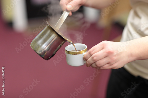 waiter pours coffee