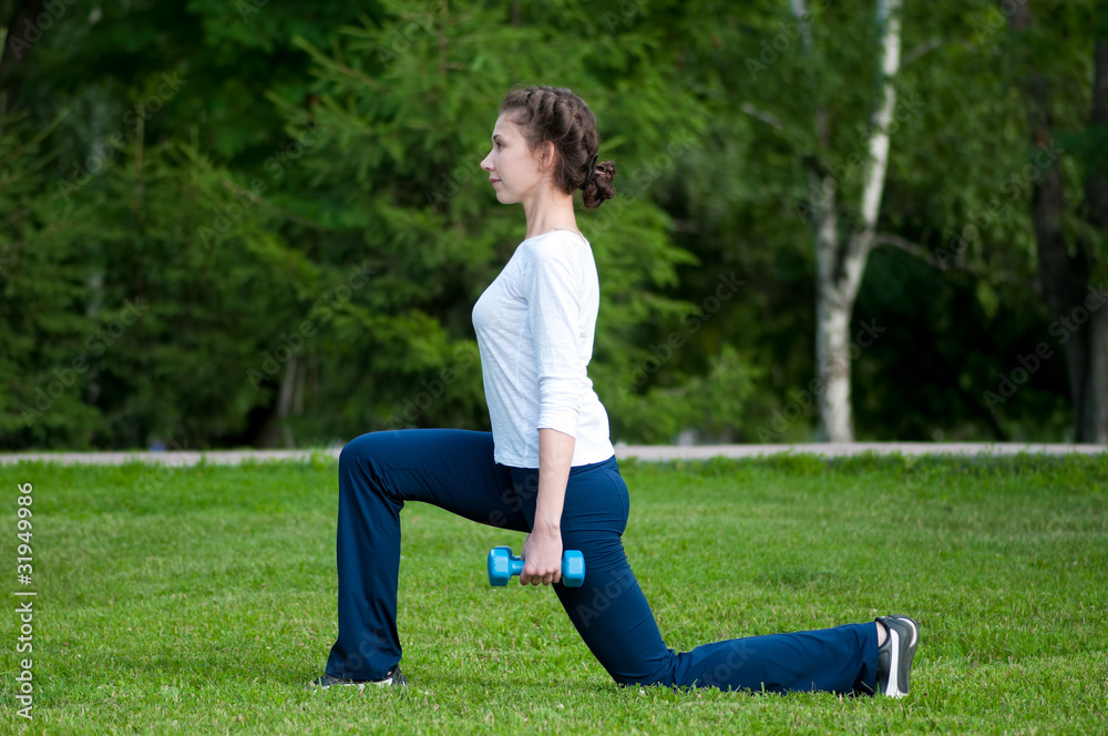 woman doing exercise with dumbbell woman doing exercise with dumbbell