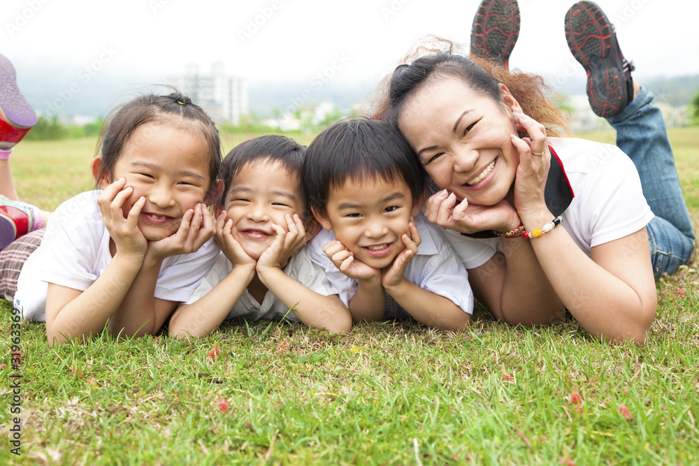 asian mother and her children on the green field asian mother and her children on the green field