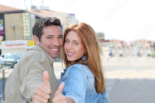 Portrait of smiling couple with thumbs up