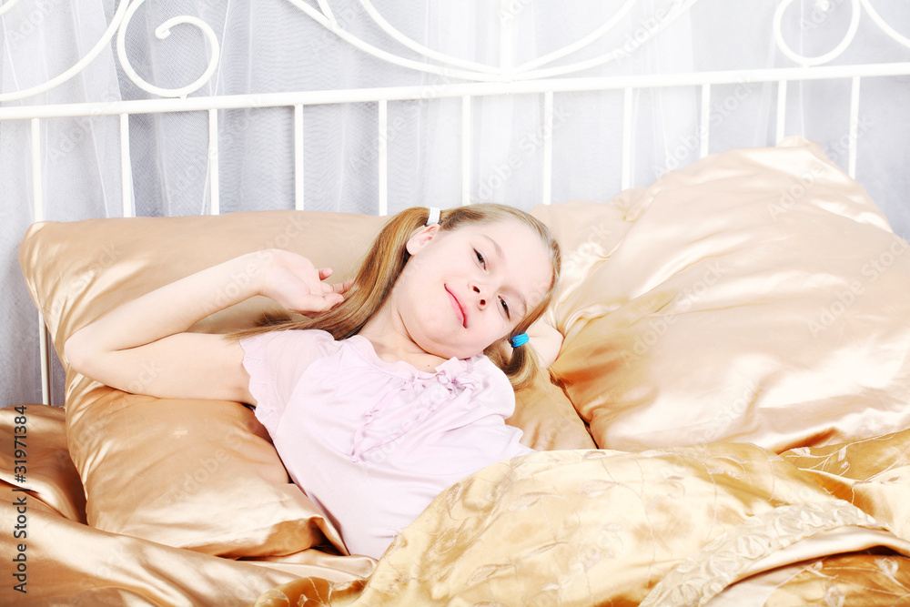 ten years' girl has woken up and stretches in bed. ten years' girl has woken up and stretches in bed.