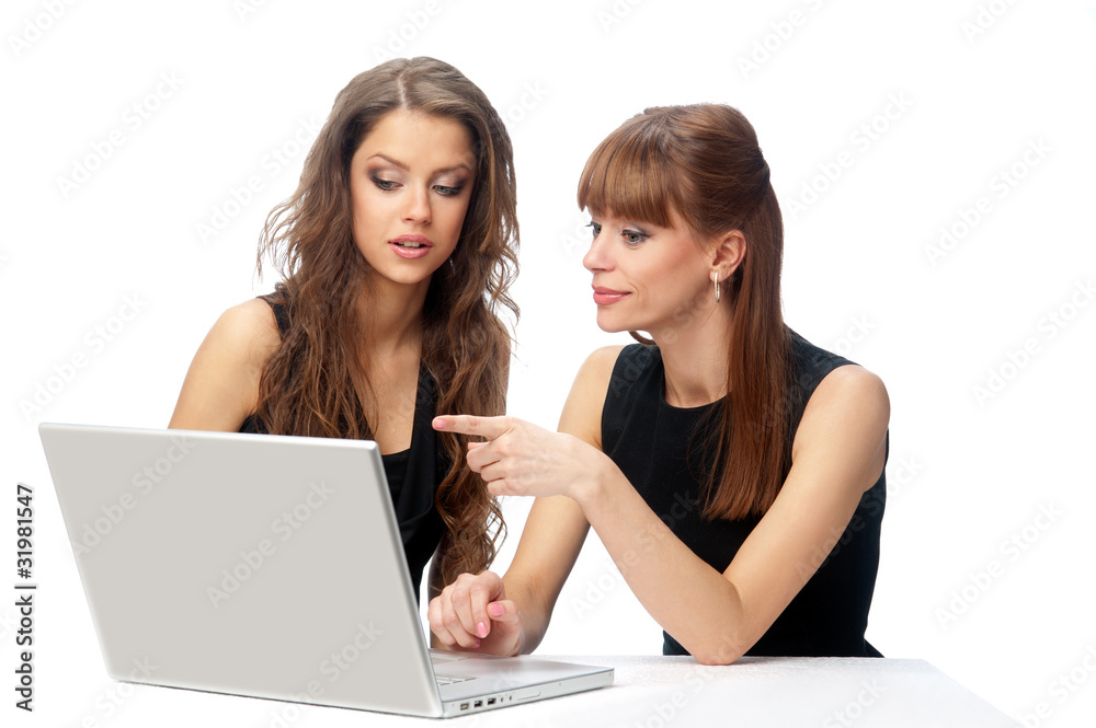 Two women working on a laptop