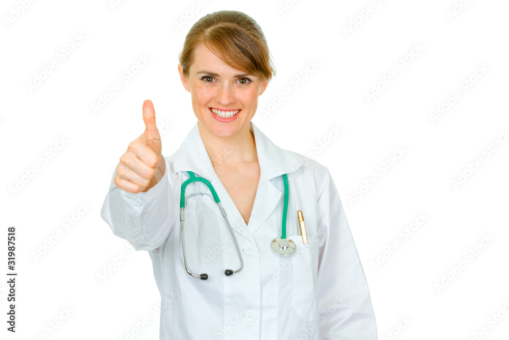 Smiling medical female doctor showing thumbs up gesture Smiling medical female doctor showing thumbs up gesture