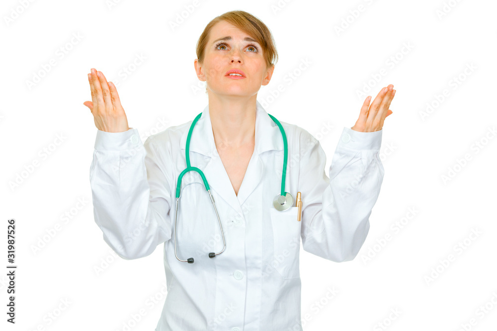 Frustrated medical doctor woman looking up and raising hands Frustrated medical doctor woman looking up and raising hands