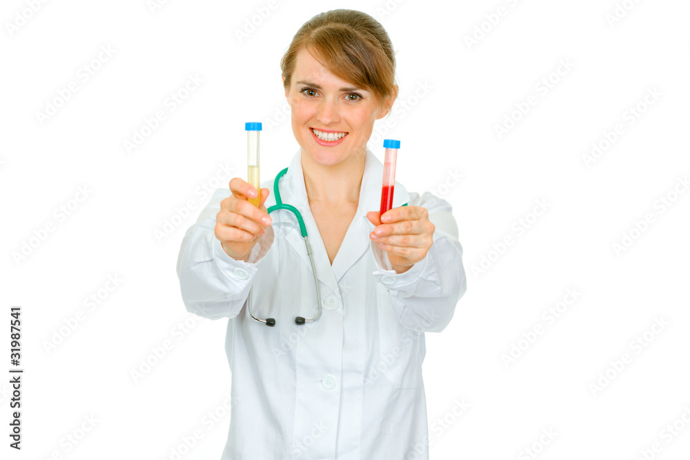 Smiling medical doctor woman holding test tubes in hand Smiling medical doctor woman holding test tubes in hand