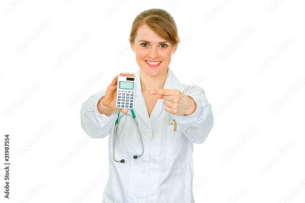 Smiling medical doctor woman pointing finger on calculator Smiling medical doctor woman pointing finger on calculator