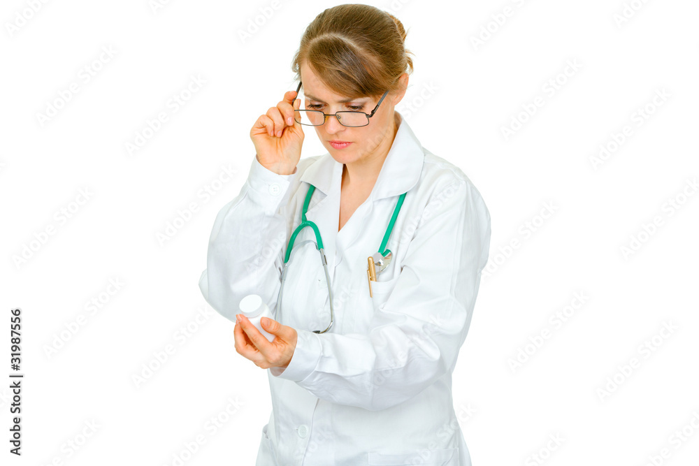 Concentrated medical female doctor reading name of drug Concentrated medical female doctor reading name of drug