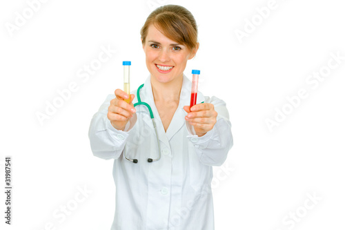 Smiling medical doctor woman holding test tubes in hand