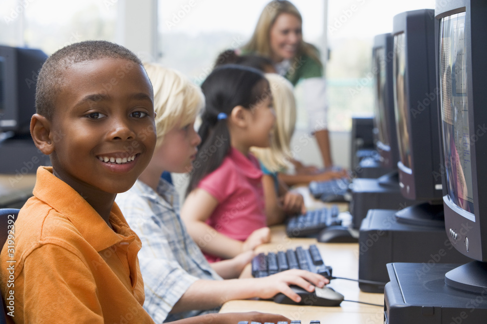 Kindergarten children learning how to use computers. Kindergarten children learning how to use computers.