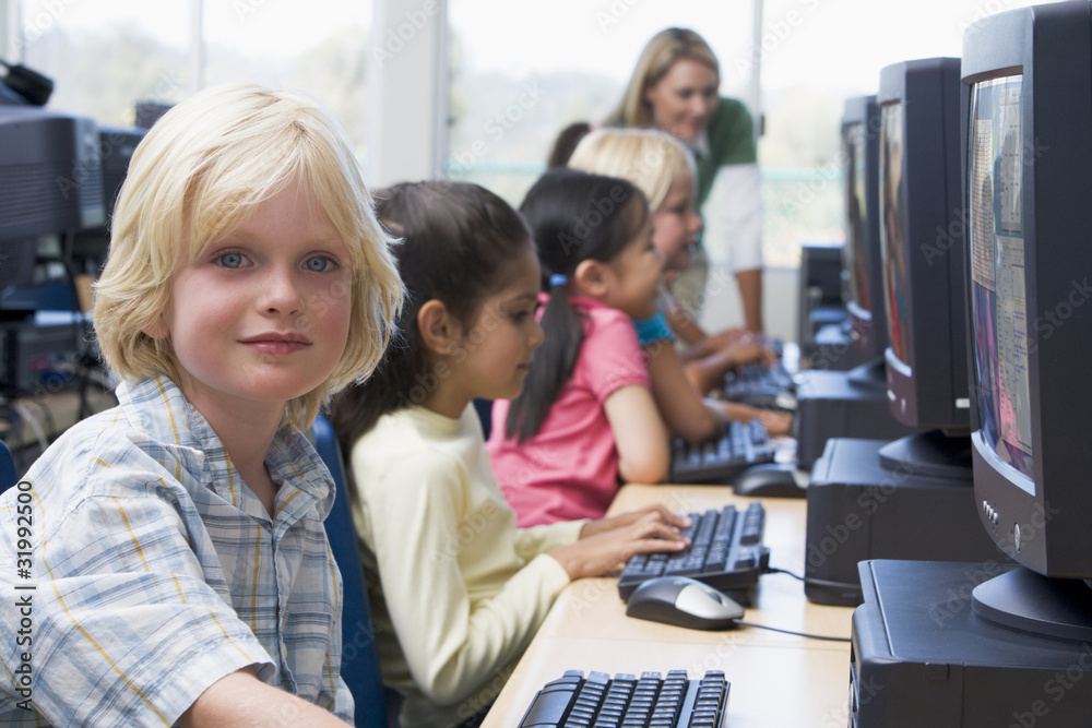 Kindergarten children learning how to use computers. Kindergarten children learning how to use computers.