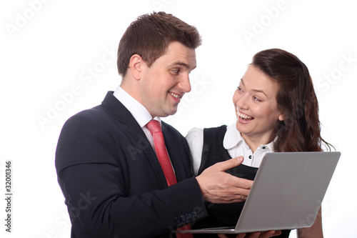 Closeup of a happy casual couple looking at laptop