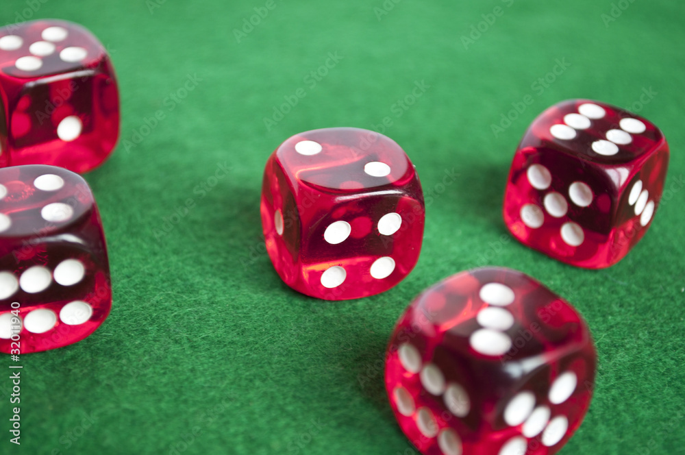 Set of gambling dices on green background Set of gambling dices on green background